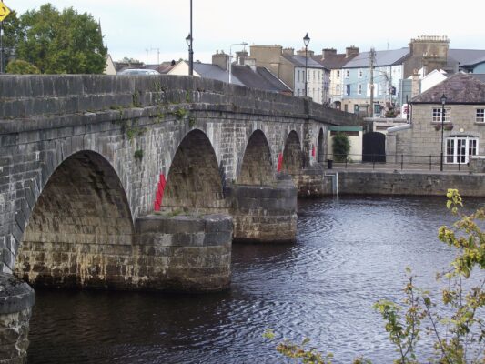 Old stone bridge over Shannon river and old town of Carrick-on-Shannon