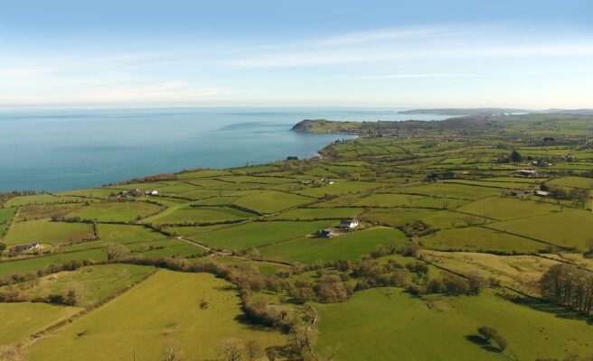 Aerial View of Green Grass Field Near Body of Water in Tyrone County
