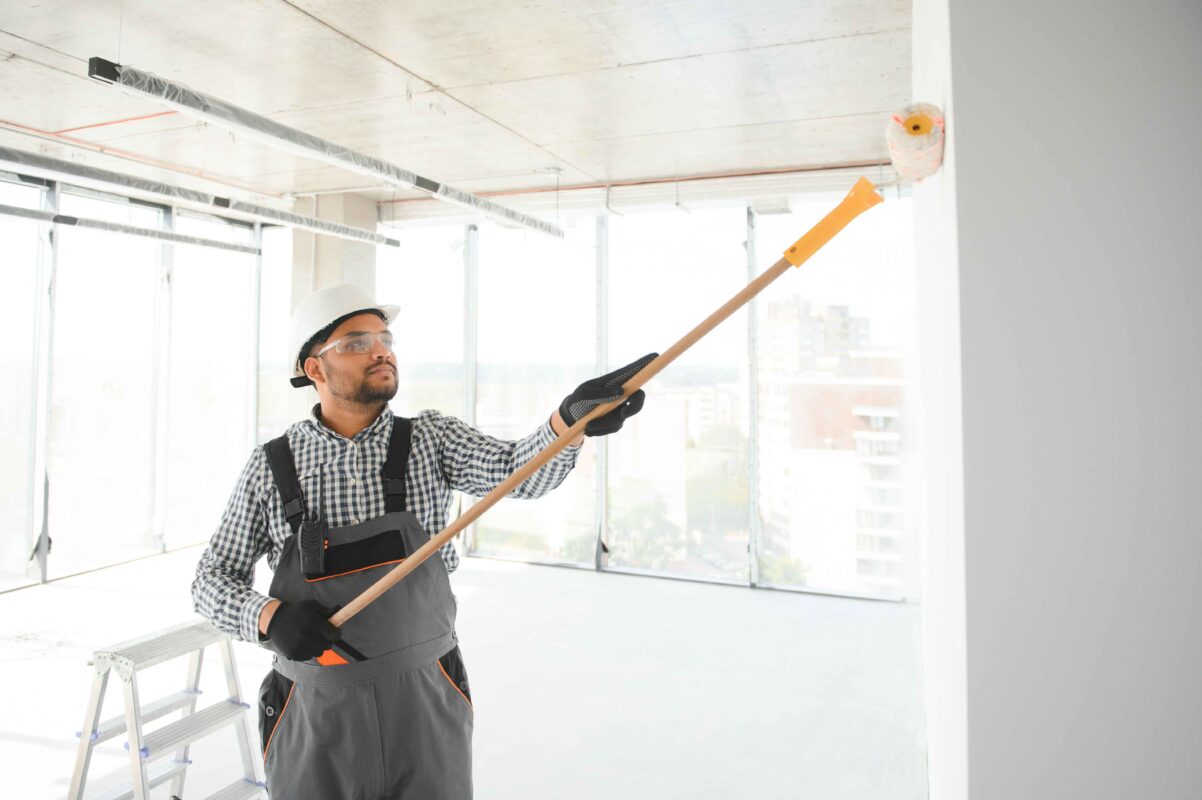 a worker painting a wall using thermal paint