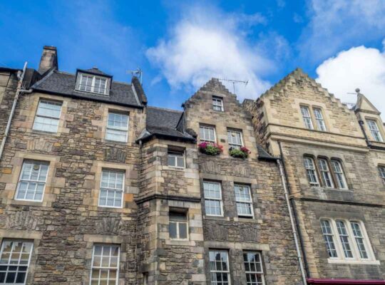 Historic multi-story stone buildings with traditional masonry and sash windows