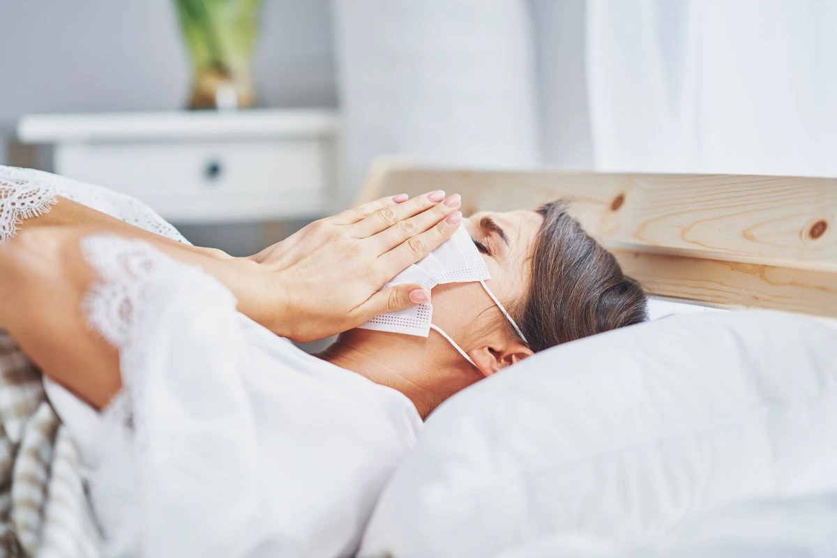 A woman lying in bed sick